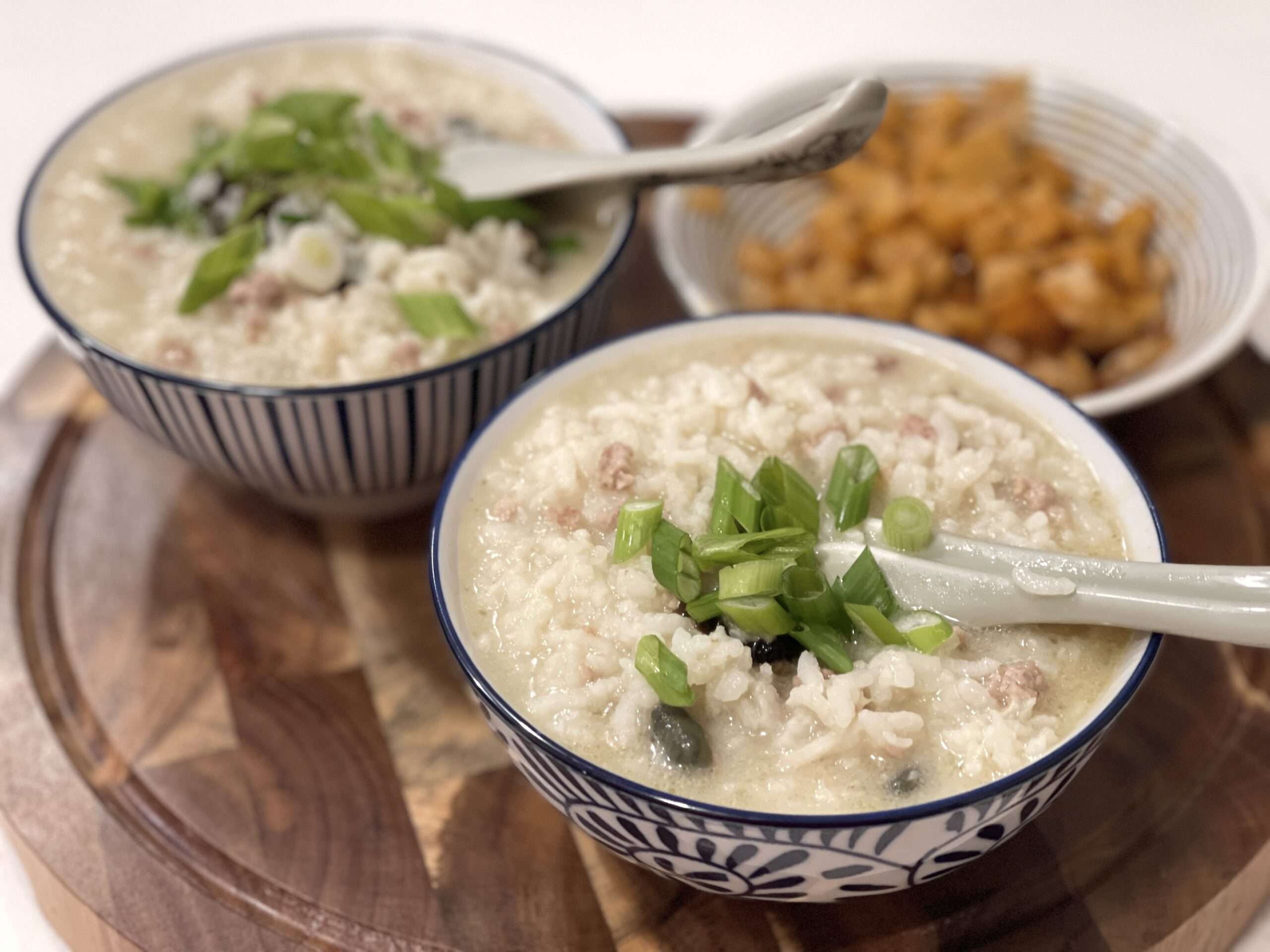 Finished congee in bowls with preserved veggies