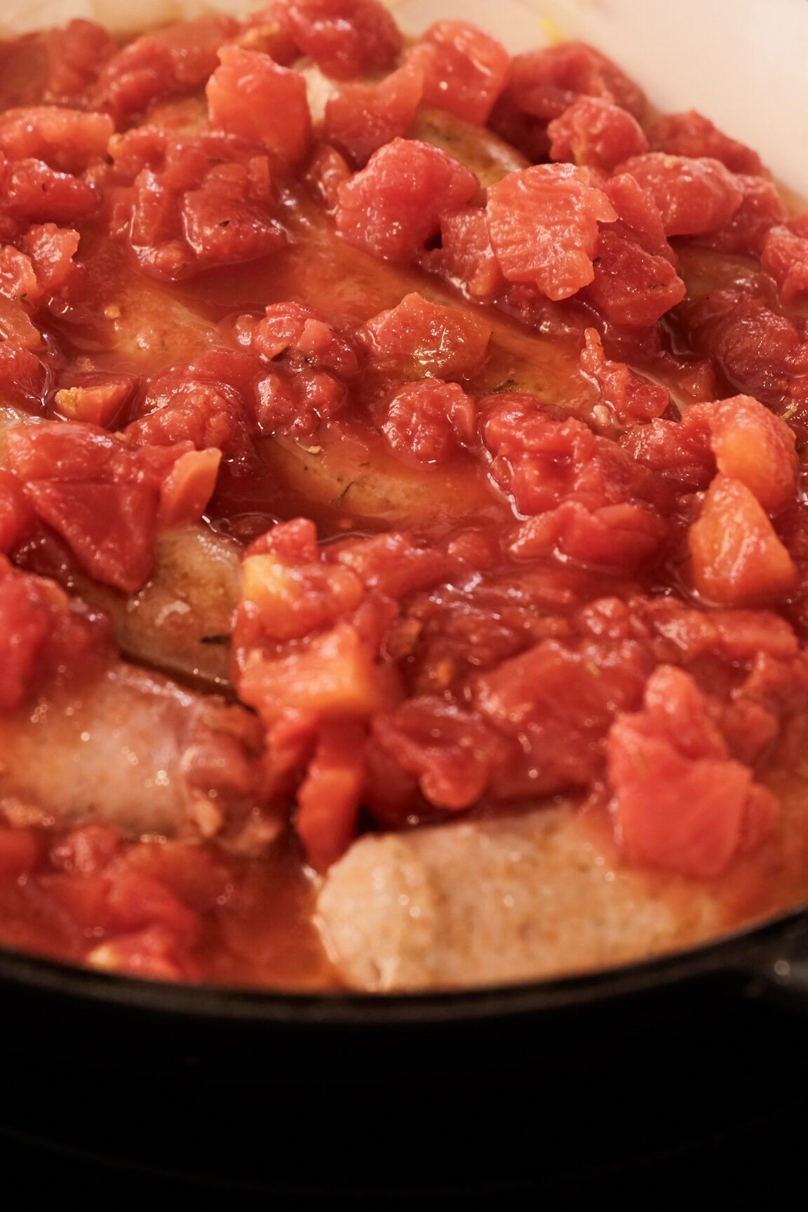 Adding diced tomatoes to Italian sausage