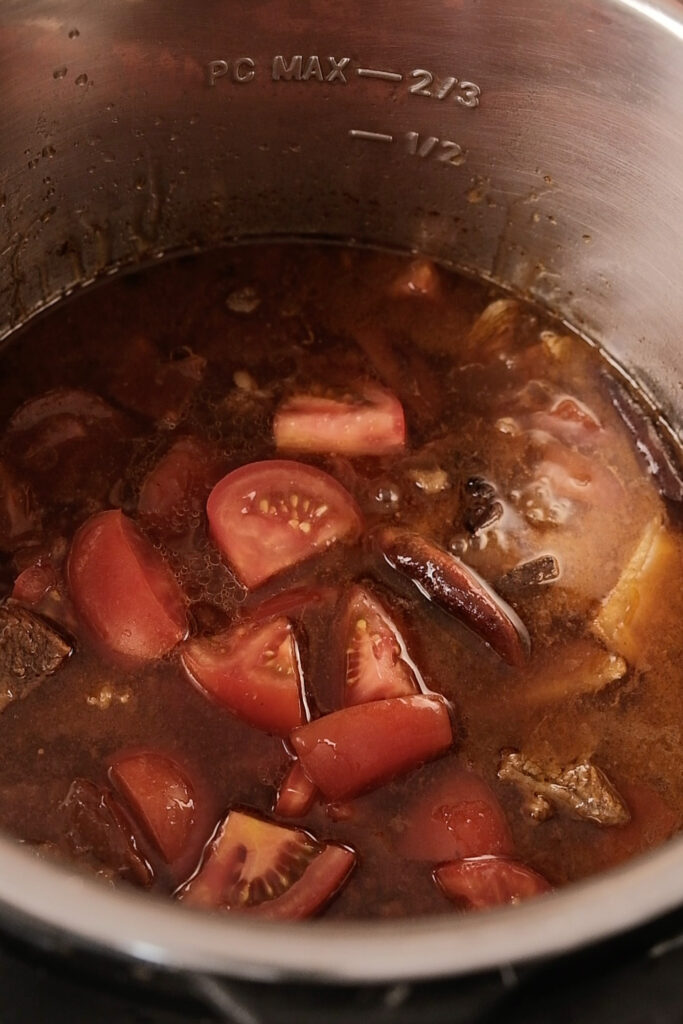 Adding more tomatoes into the soup