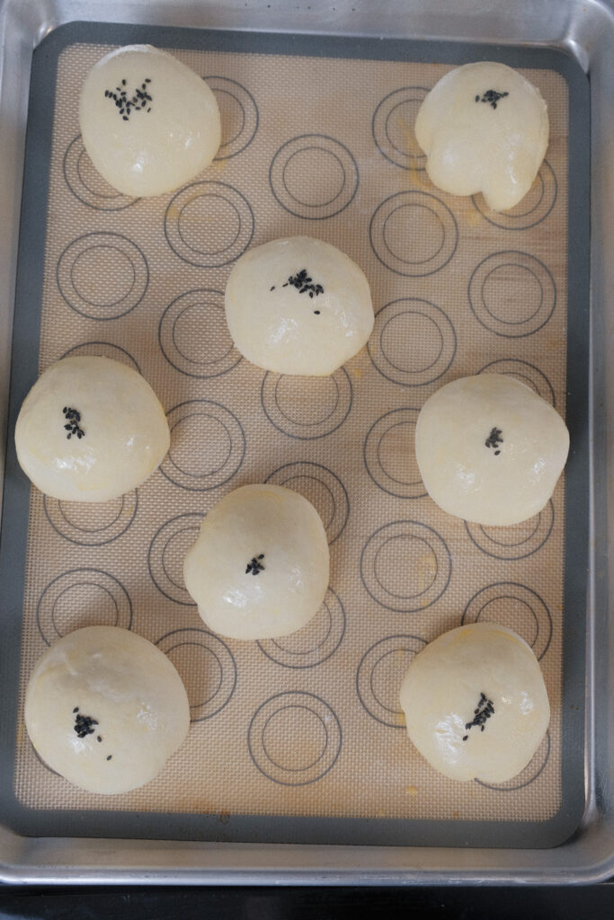 red bean bun with egg wash and sesame seeds