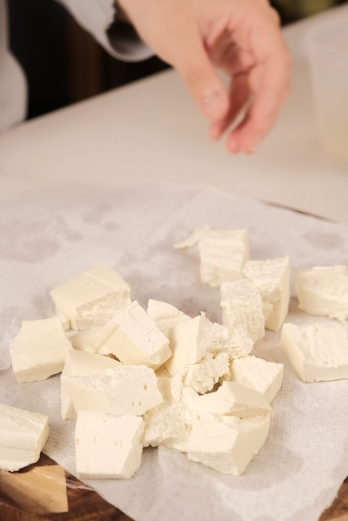 Breaking tofu into pieces