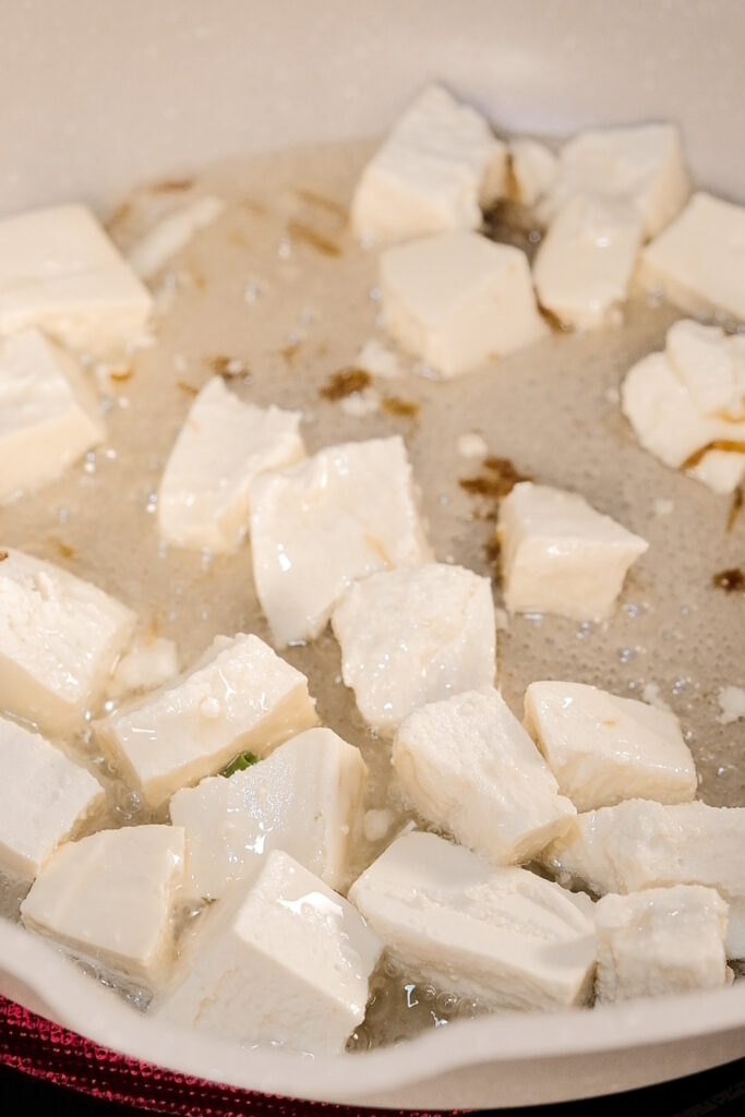 Frying the tofu in the onion infused oil