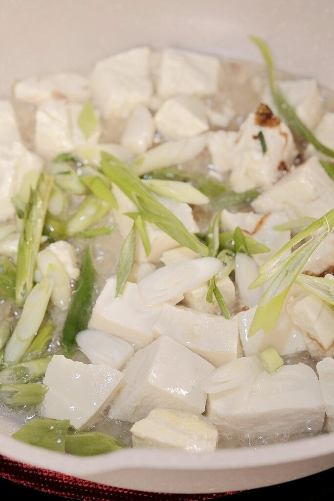 Frying the tofu with scallions