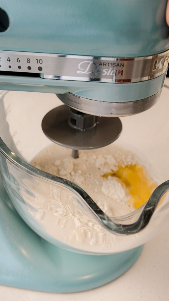 initial mixing of the dough with flour, sugar, milk, yeast and egg