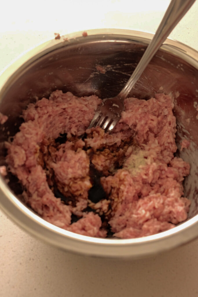 Adding seasoning to dumpling filling