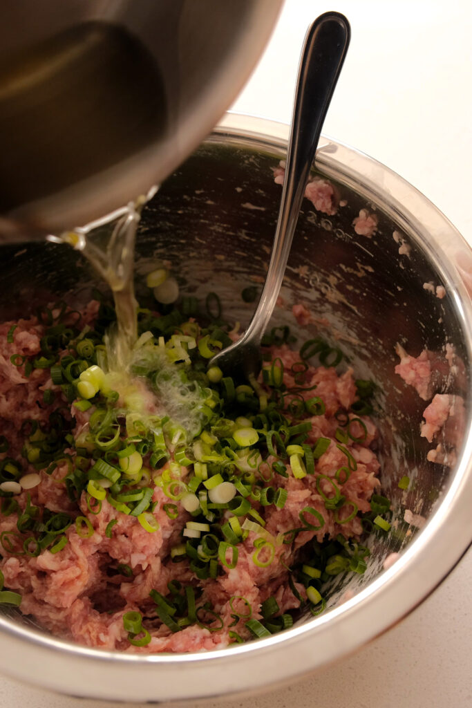 Adding hot oil to ground meat