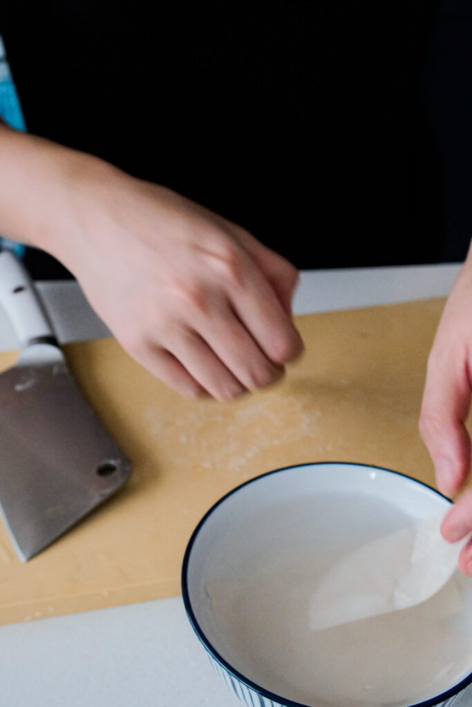 Soaking dumpling wrappers in water