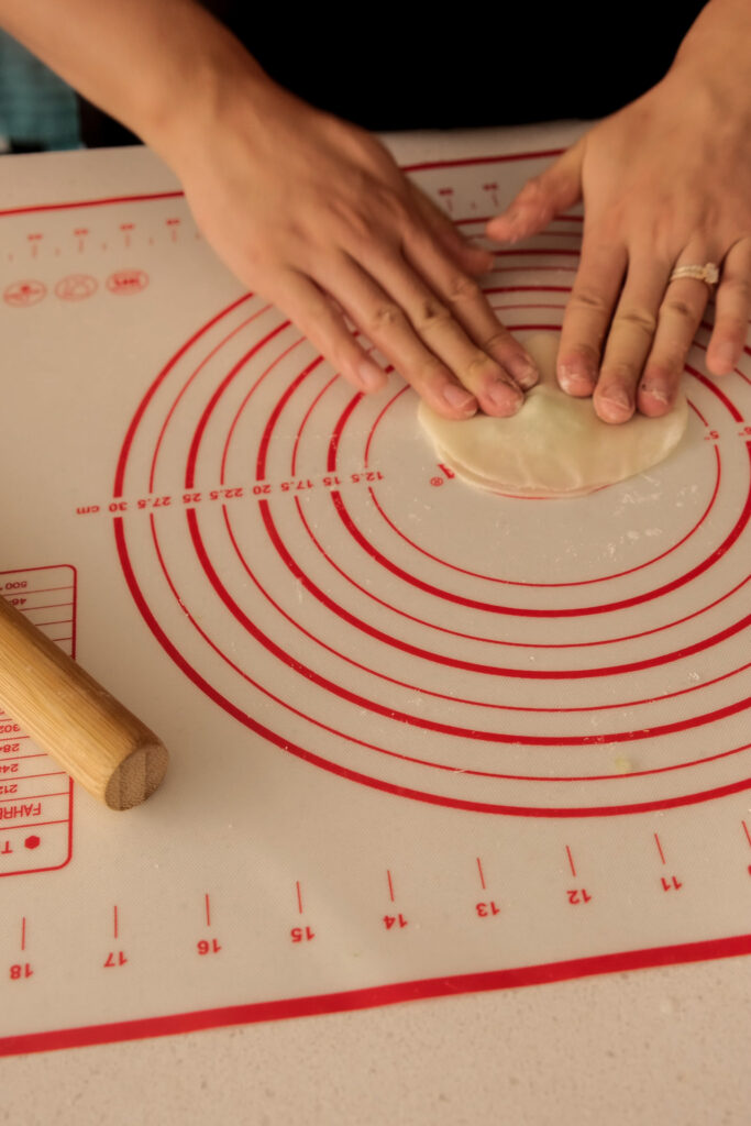 Putting dumpling wrappers together with scallions in between