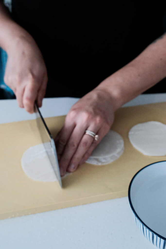 Cutting the dumpling wrappers into halves