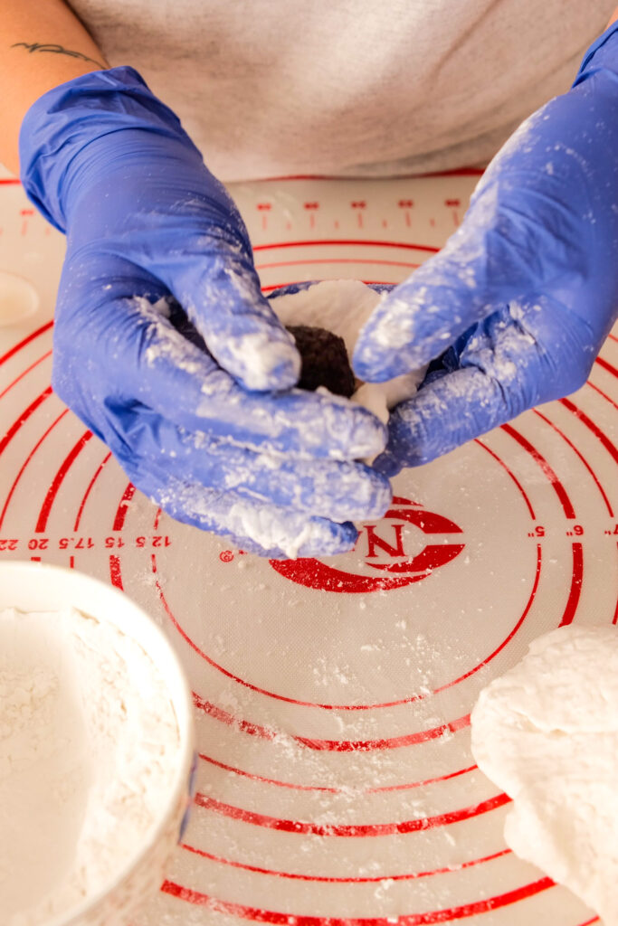 Pushing the dough to wrap the red bean paste