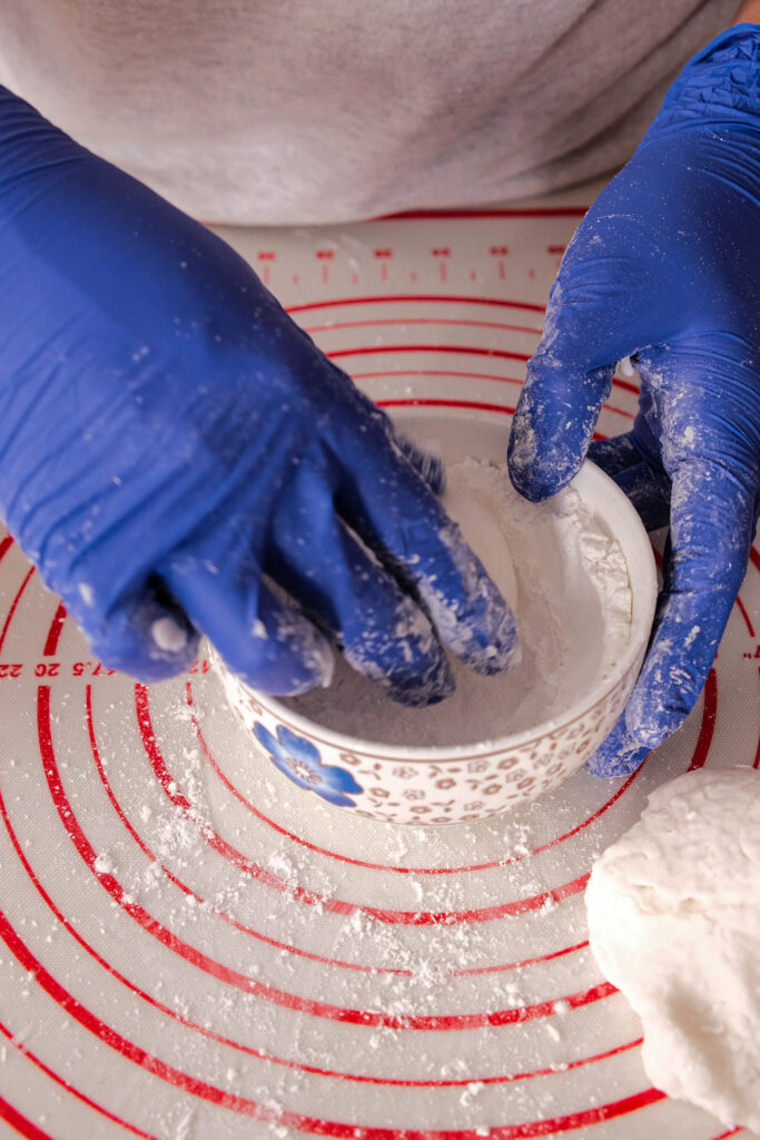 Rolling mooncake dough in rice flour