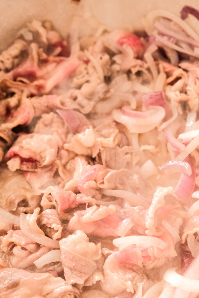 beef brisket is being stir fried