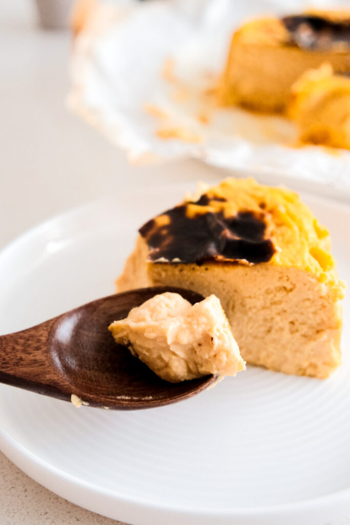 Spoon taking a piece of cheesecake
