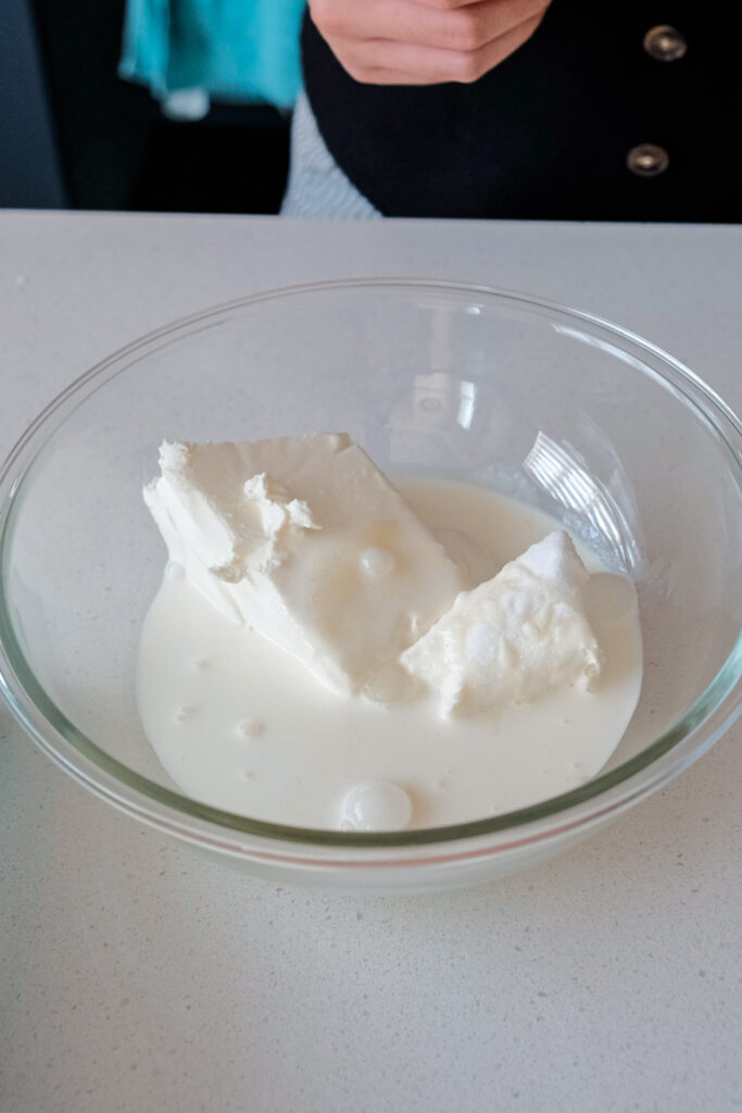 Cream cheese, sugar and whipping cream in a bowl