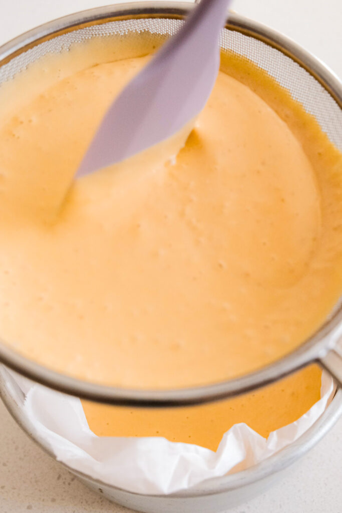 Using a spatula to strain batter