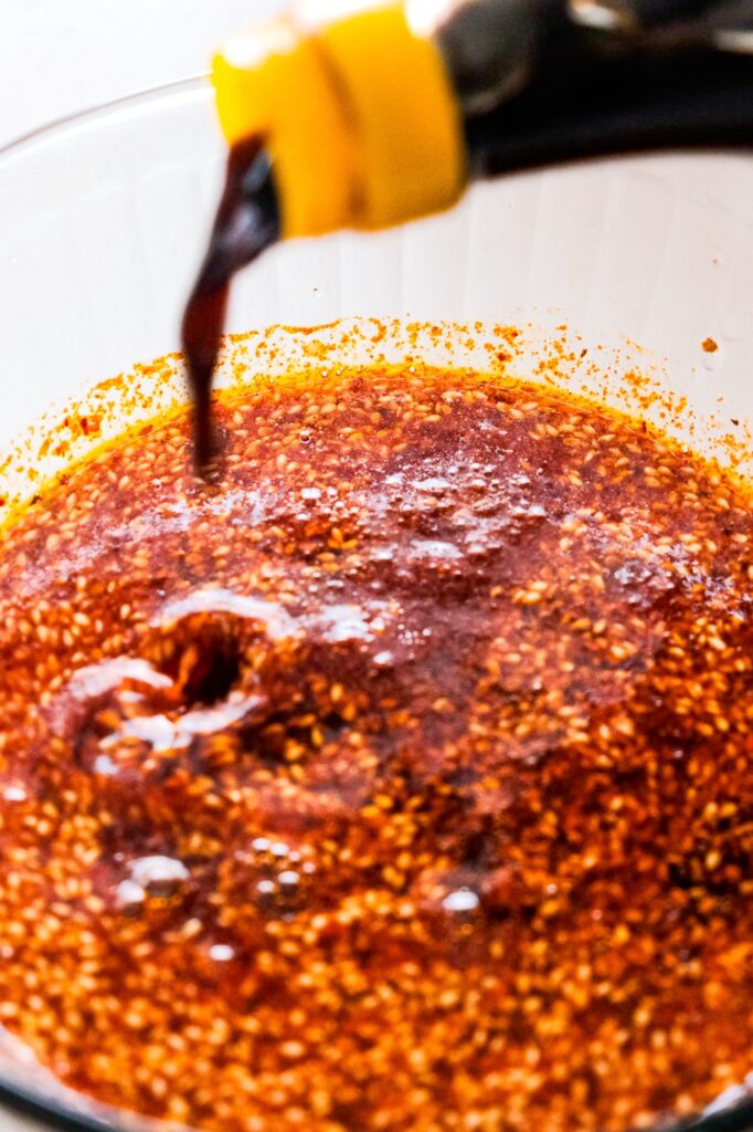 Pouring vinegar into chili oil