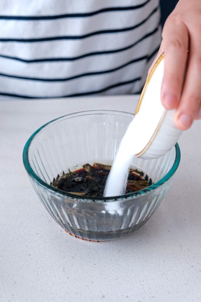 Pouring sugar into scallion sauce
