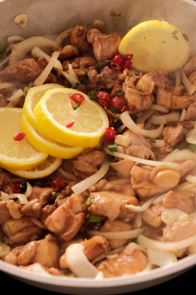 Adding lemon and thai chili into the chicken