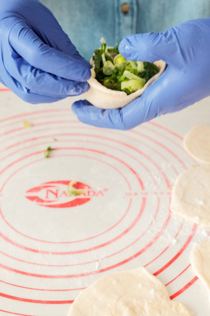 Demonstrating how to close the beef pie