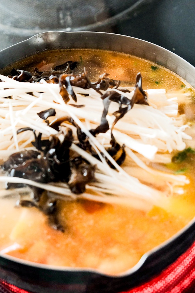 Adding enoki and wood ear mushroom